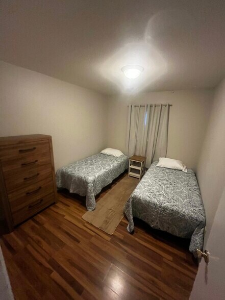 One bedroom has two twin beds second room has a queen bed - 1026 N Jefferson St