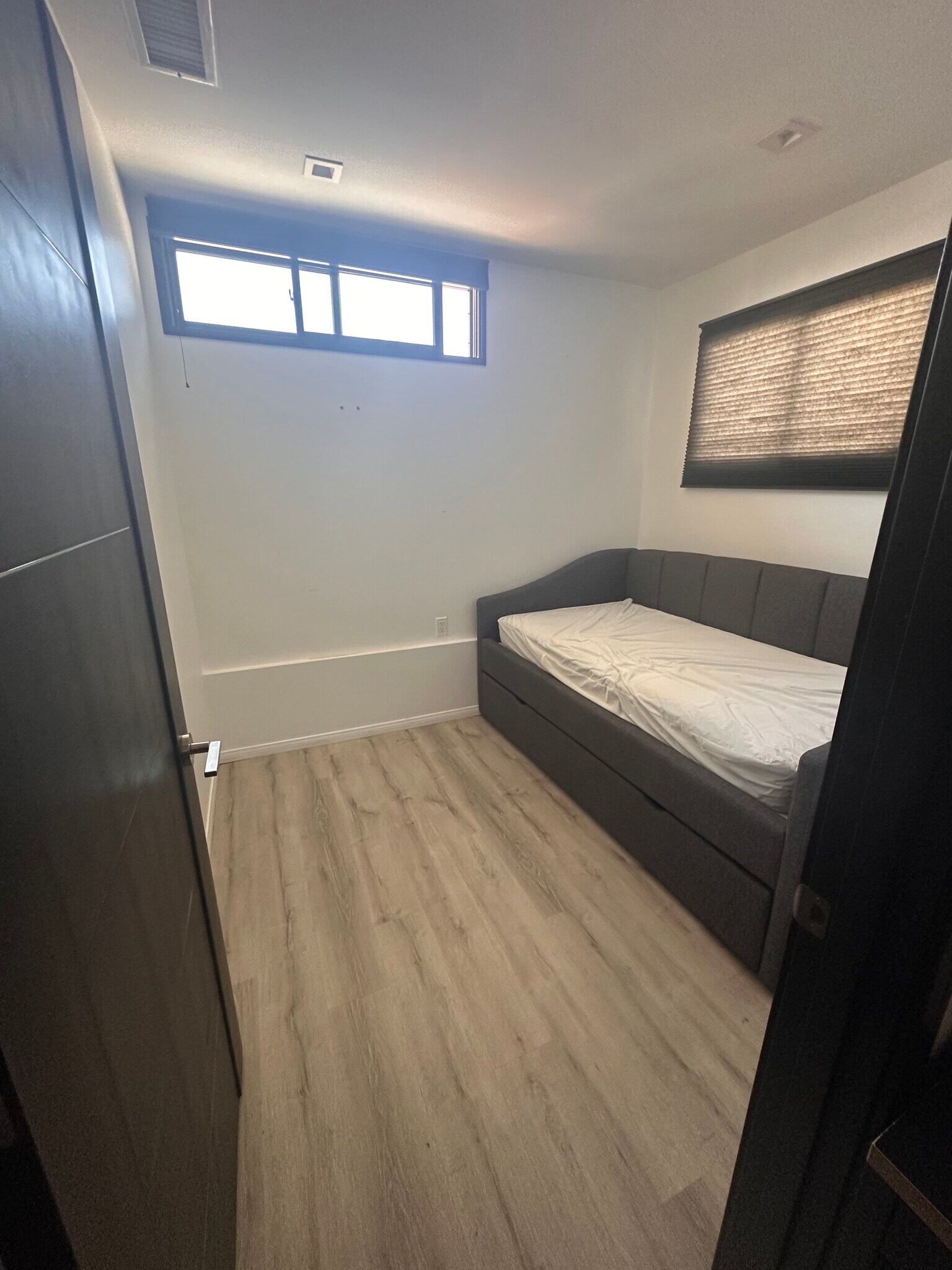 Smaller bedroom with twin bed with quality bedding, and there is a giant drawer under the bed - 3426 Gurnard Ave