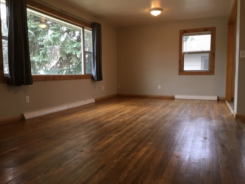 Check out the original hardwood floors in this inviting livingroom. - 829 3rd Ave W