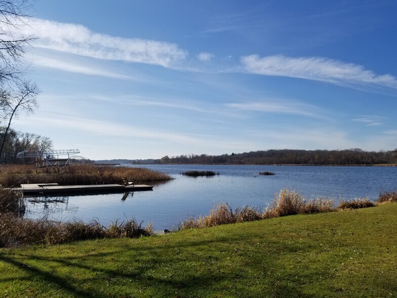 View of the Kettle of Lake Nagawicka by fire pit and seating area - 1623 Kettle Cove Ct