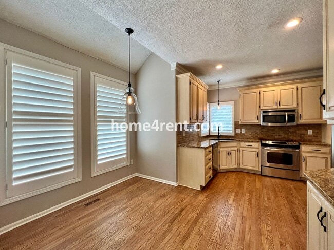 Building Photo - Updated Kitchen, Large Two Tiered Deck, Finished Basement in Blue Valley Schools!
