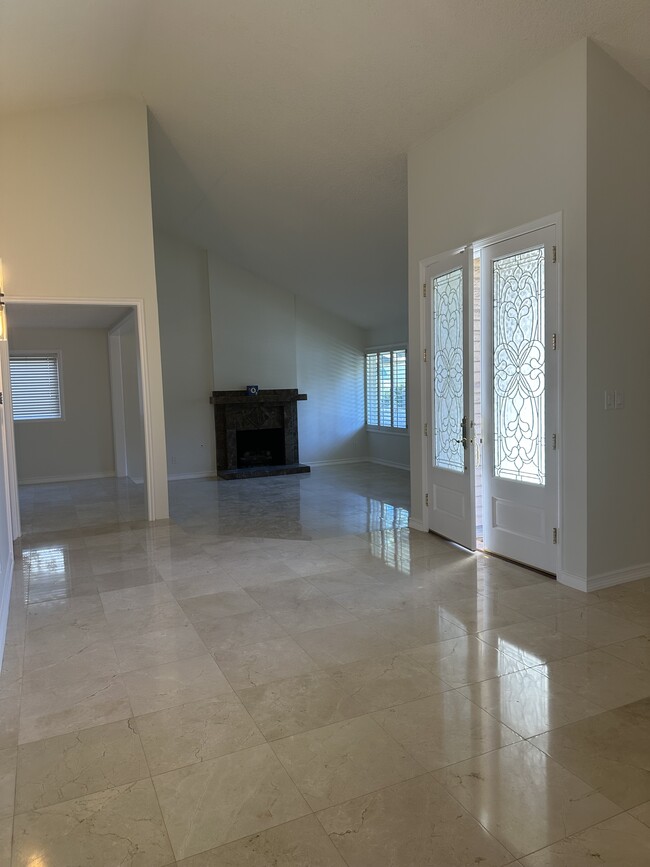 Italian marble floors and fireplace in living room. - 3816 San Augustine Dr