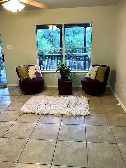 living room with hard tile floors has a view of the deck and back yard - 10617 Garbacz Dr