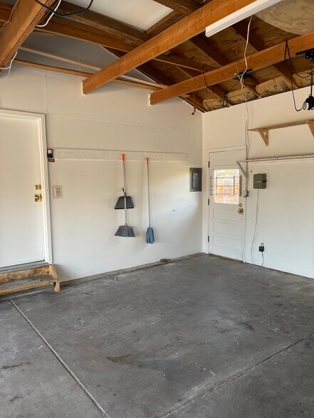 Two car garage with plenty of shelving - 7991 E Hampden Cir