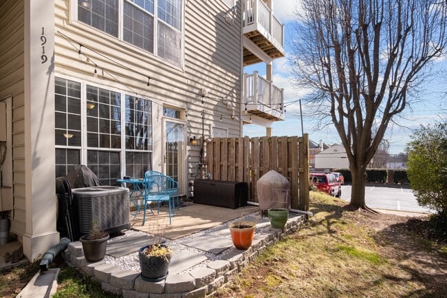 Building Photo - This inviting two-level townhome offers comfort and style, featuring gleaming hardwood floors on ...