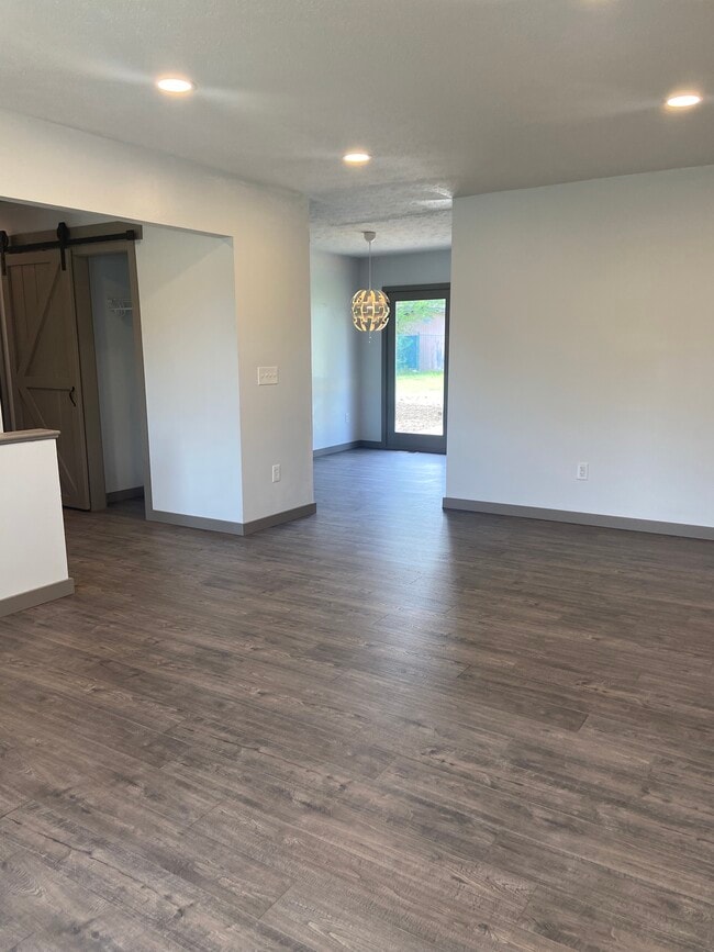 Large living room looking into kitchen with view of coat closet - 174 Brisbane Ave