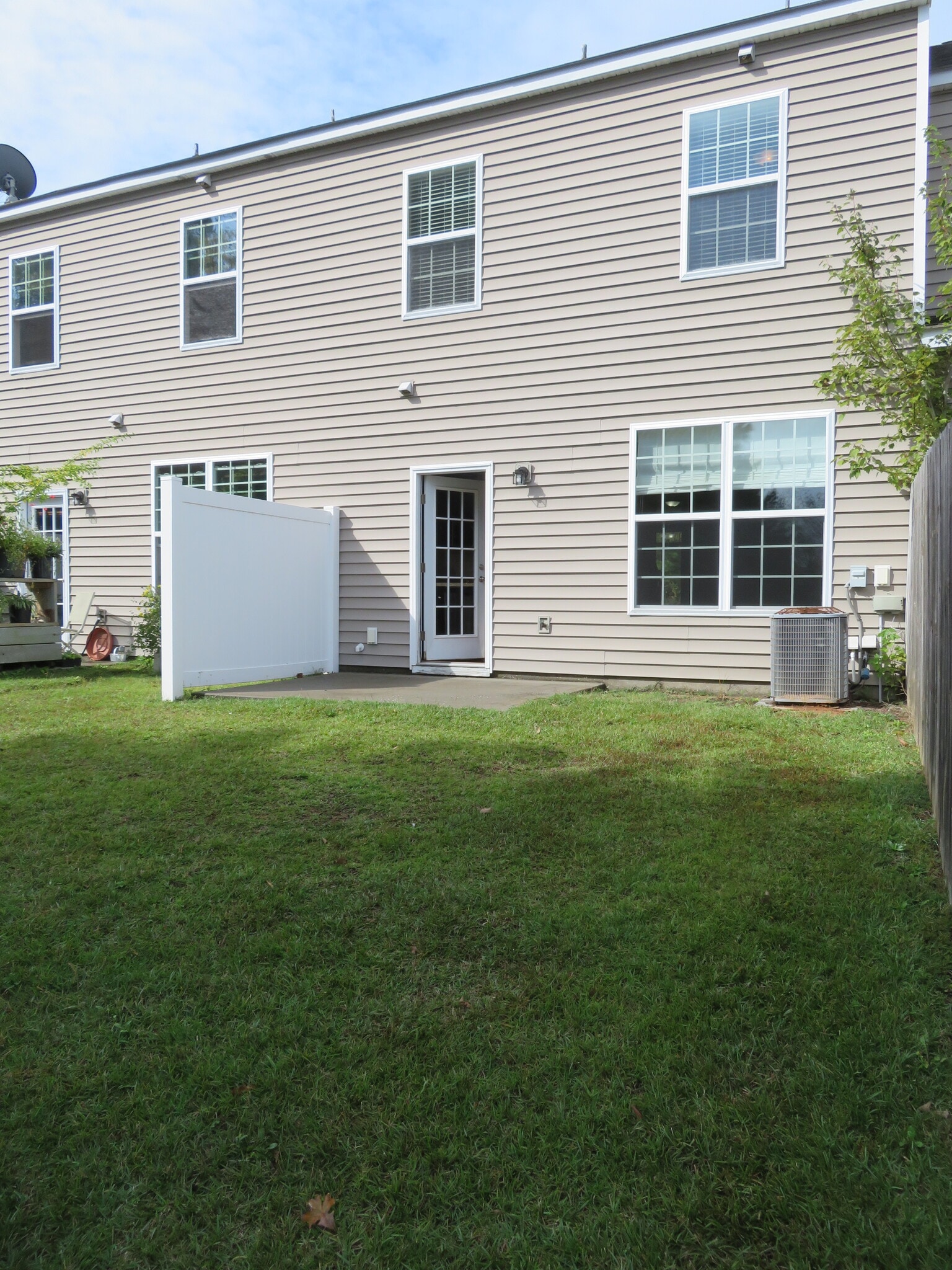 Backyard through French door in kitchen. *Note - white vinyl privacy fence on the left of the patio - 2496 Stadium Dr