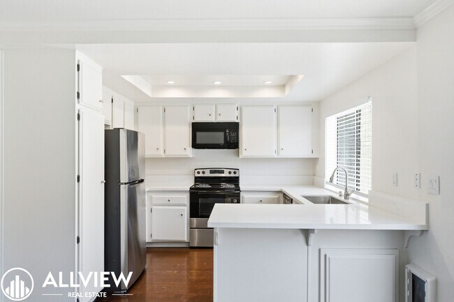 Building Photo - Fully Renovated 2 Bed Townhome with Private Patio, 2-Car Garage & Community Pool