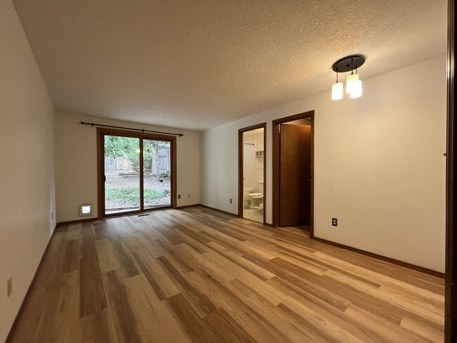 Building Photo - Spacious 3-Bedroom Home with Custom Stone Fireplace, Attached 2-Car Garage & Expansive Backyard i...