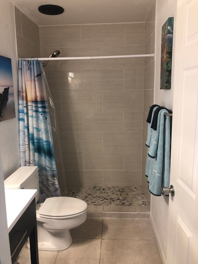 Adjustable shower head river rock bottom new tiles installed - 7142 Kamehameha V Hwy