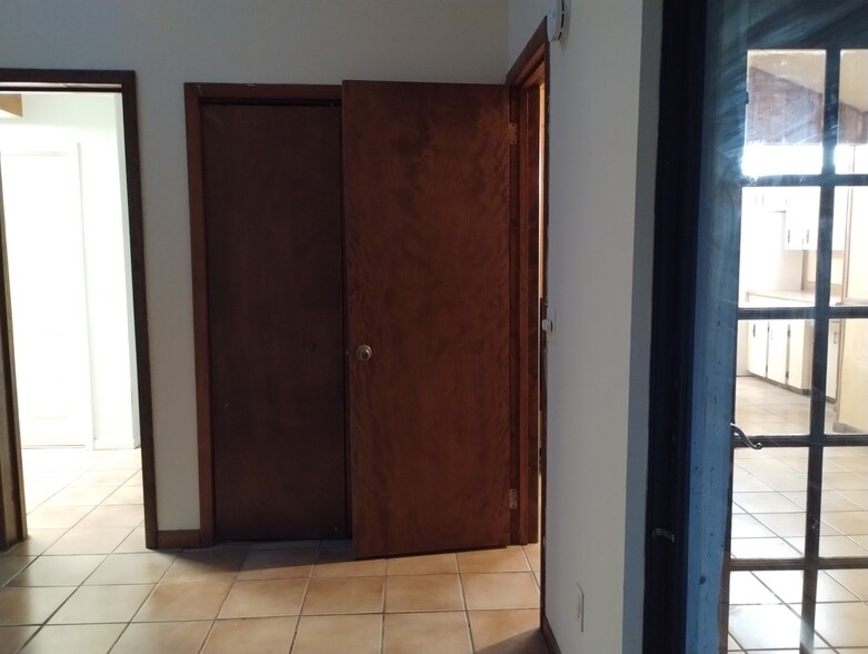 Master bedroom and closets with view through sliders & French door into dining room and kitchen - 9018 SE Hobe Ridge Ave