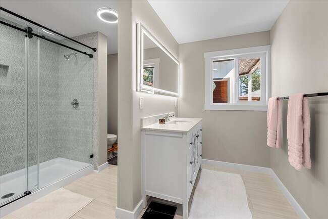 Master bathroom with modern, light up mirror and walk-in shower. - 4206 N Winnifred St