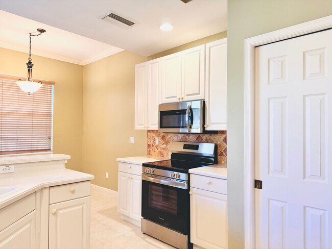 Building Photo - Experience Bell Tower Park. GATED ground floor 2 Bed 2 Bath Den 1 Car Garage Condo.