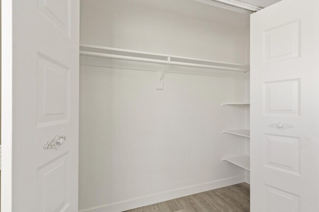 Explore the elegance of this modern walk-in closet, perfect for organizing your wardrobe. - Country Club
