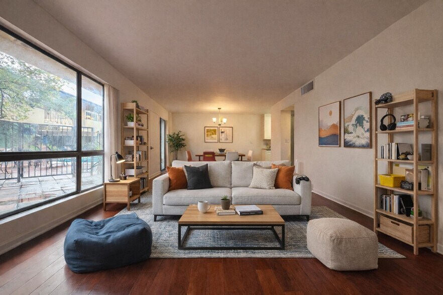 Bright, open living space with hardwood floors and direct views of the pool courtyard - 970 Palm Avenue