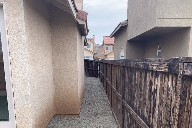 Side of house w/ 3 in of pea gravel & drains - 9219 Canyon View Ave