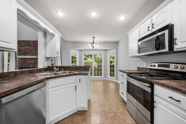 Building Photo - Stunning Stone Fireplace • Finished Basement • Fenced Yard