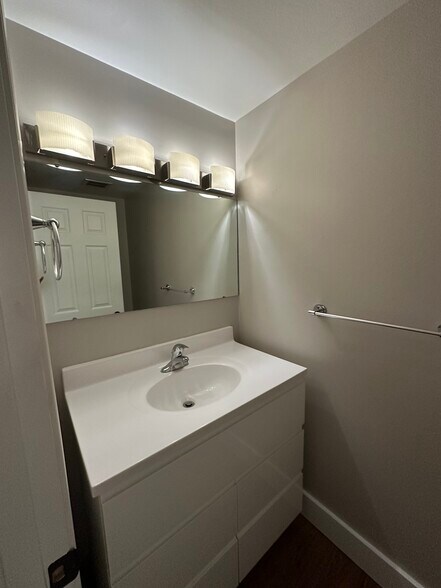 Half bath with custom vanity and raised toilet. - 2154 Willowgrove Ave