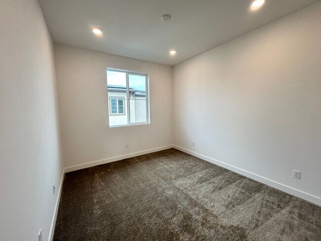 Building Photo - Gorgeous, 3 level townhome, featuring 2 car garage central Air, and in Unit laundry.