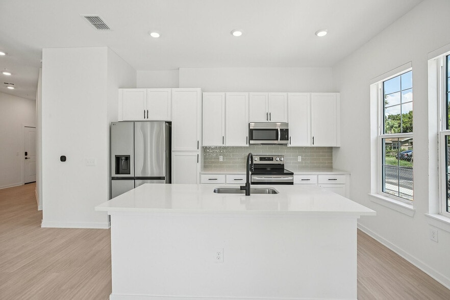 Kitchen with White Cabinets - Evelyn City Lofts
