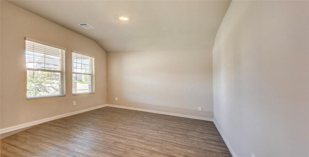 Dining room with wood finished floors. Can be turned into office. Vaulted ceilings - 1109 Birchwood Ln