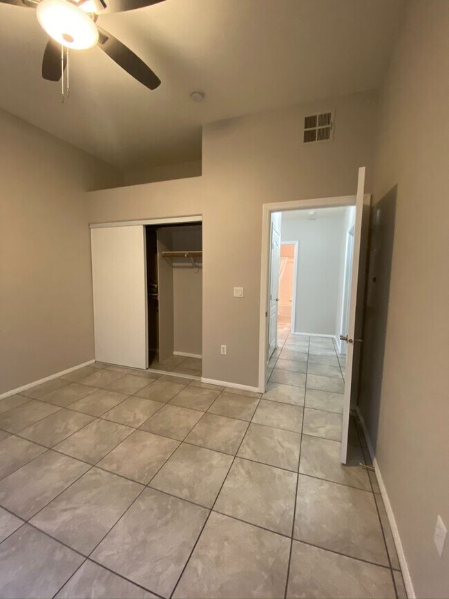 Building Photo - BEAUTIFUL CONDO IN A GATED COMMUNITY FEATURING PLANTATION SHUTTERS, TILE FLOORING AND NEW PAINT T...