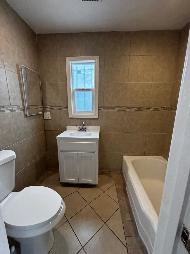bathroom with shower and tub - 3740 W Slauson Ave