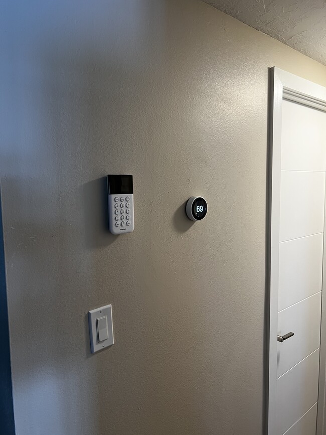 Security system and Nest Thermostat in Hallway - 600 Sutton Plz