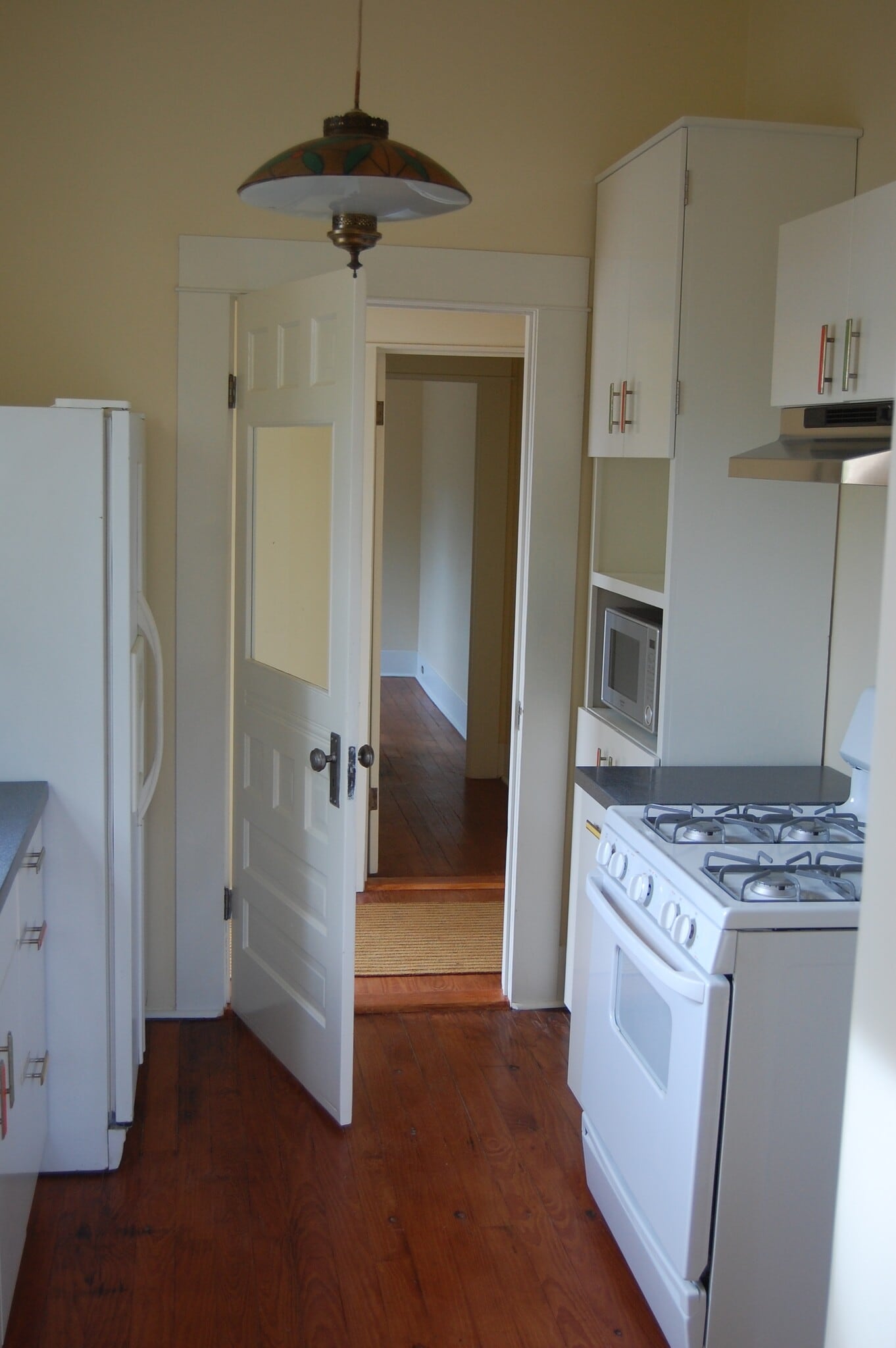 Kitchen looking toward the entry hall that leads to the bathroom and the small bedroom or office - 704 E Guenther St