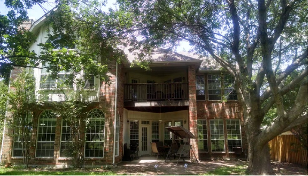 Elegant tree-lined backyard with two patios - 10913 Alexandria Dr