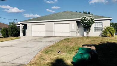 Building Photo - Experience this 3 bedroom 2 bath duplex with 1 car garage and screened in Lanai.