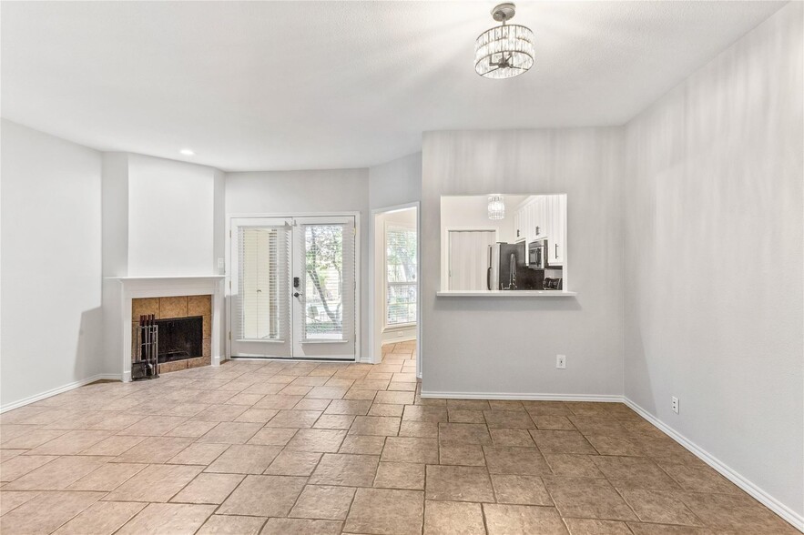Living area with a wood burning fireplace - 14277 Preston Rd