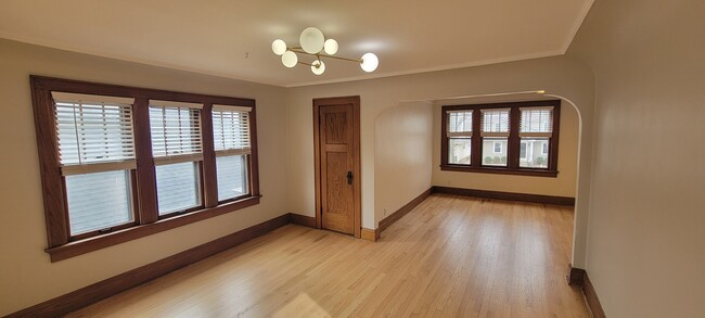 Refinished original flooring throughout. This is the dining room looking into the living room - 2410 N 65th St