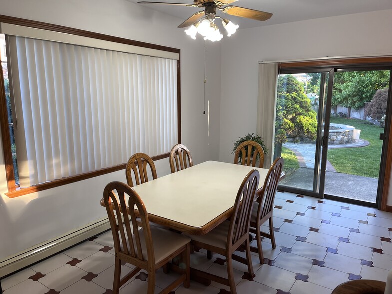 large eat in kitchen with under stair storage/pantry bay window and sliding door to garden area - 239 Kingston Ave