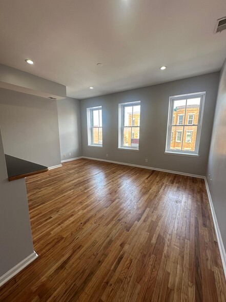 Living/dining room area. Includes high ceilings, LED recessed lights, and REAL hardwood floors - 1426 Madison Ave