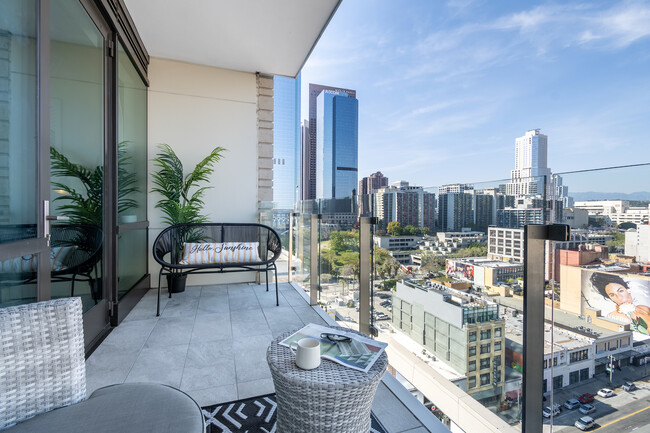 Stepping onto the balcony, you’re greeted by a cozy seating area and a sweeping panoramic view - 400 S Broadway