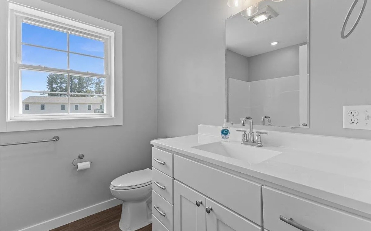 The main bathroom vanity is huge with tons of drawer space and a giant mirror. - 24 Wilsons End Pl