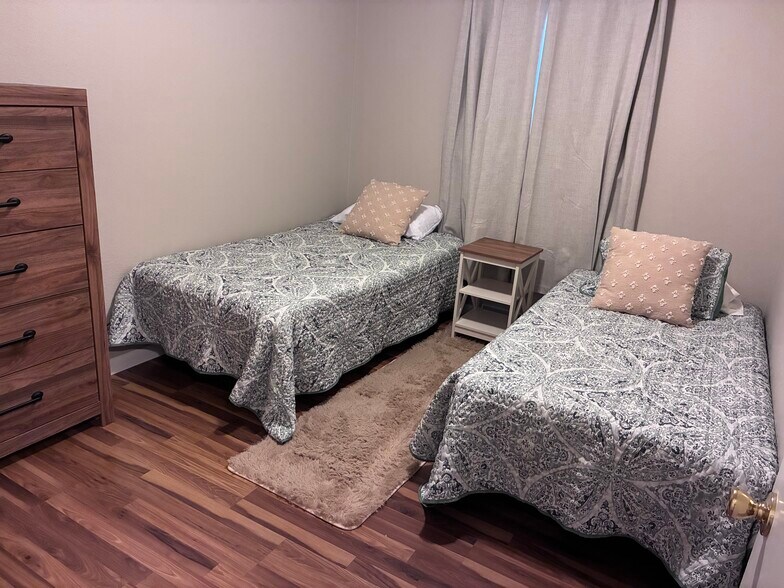 Twin beds in second bedroom with dresser and large closet - 1026 N Jefferson St