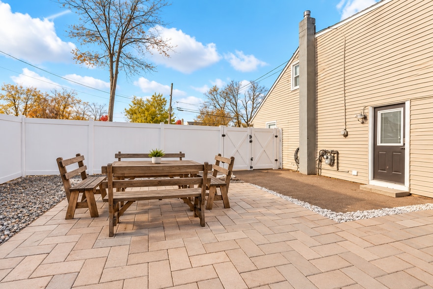 Weathered wood patio dining set featuring a spacious rectangular table. - 237 Johnson Ave