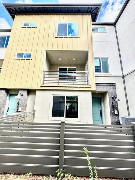 Outdoor view with patio on first floor and balcony on second floor. - 14350 Savannah Ct