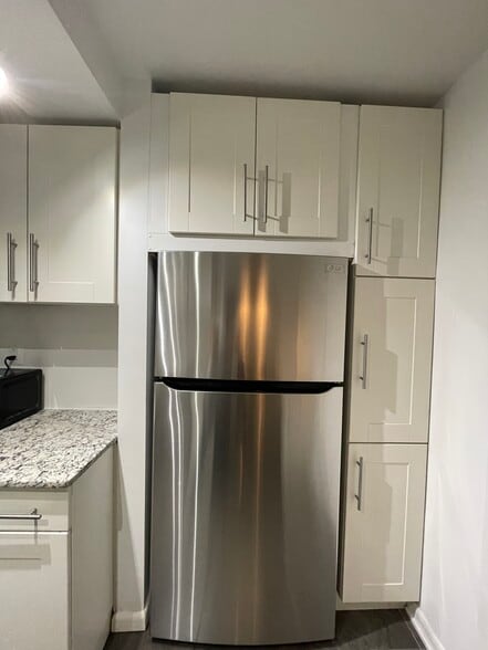 Kitchen shelving and fridge - 4201 Cathedral Ave NW