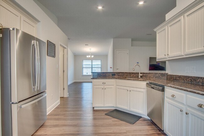 Building Photo - Spacious 4BR/2BA Brick Home with 2-Car Garage, Granite Kitchen, Vaulted Ceilings & Fully Fenced B...