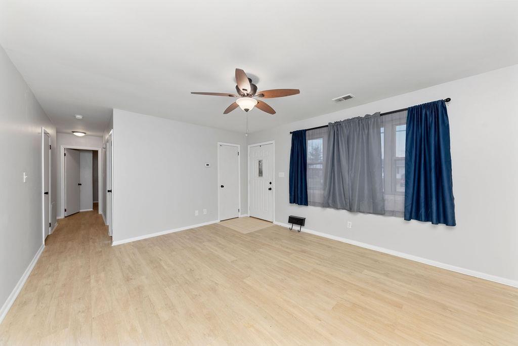 Light and bright living room with ceiling fan, solid surface flooring - 11 Lawndale Ave