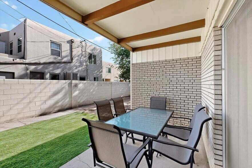 fully enclosed backyard with patio furniture, grill - 4715 Marquette Ave NE