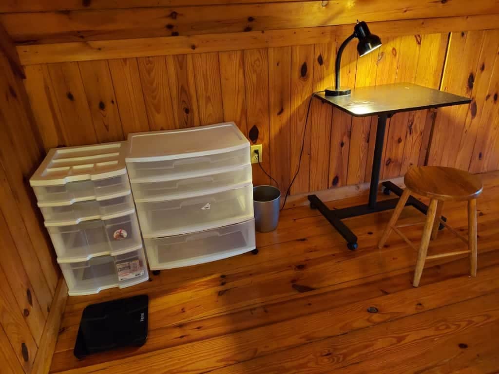 Detail of storage drawers and small desk with lamp and stool - 311 Newton Aly