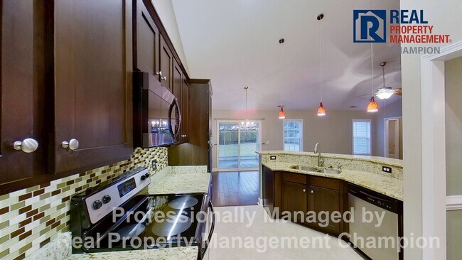 Building Photo - Beautiful home boasts open floorplan, screened porch, and spacious fenced yard