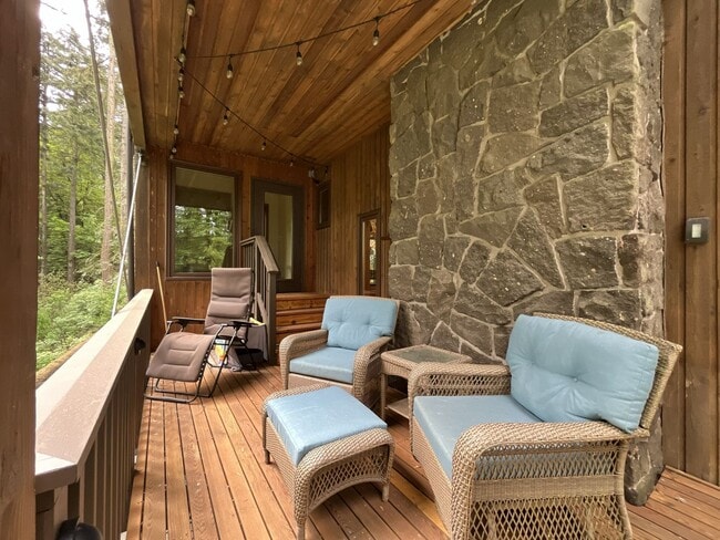 Building Photo - One-of-a-Kind Custom Home with Wall of Windows, Stone Fireplaces, Expansive Entertainment Space &...