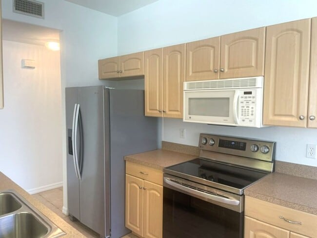 Building Photo - Elegant 3 Bedroom End-Unit Condo with Screened Lanai & Pond Views and A Private Garage