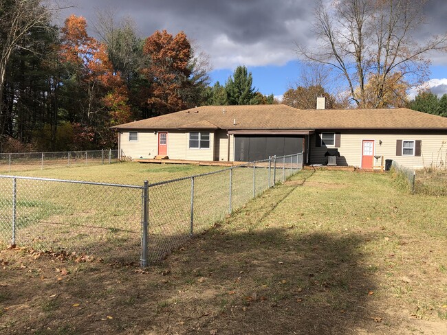 Back of house with dog fence - 12898 Lincoln Lake Ct