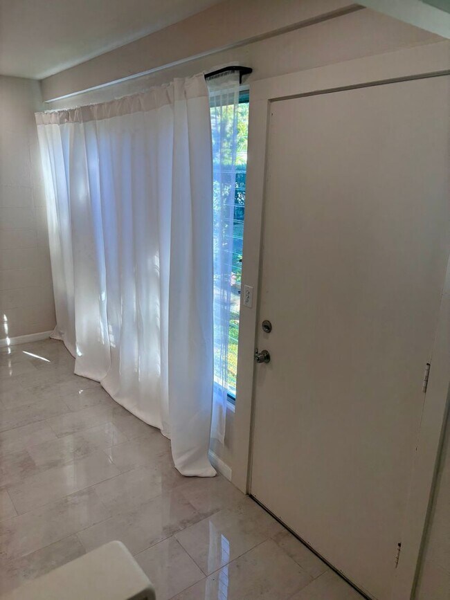 Building Photo - Available Now | 2 Bedroom, 2 Bathroom Townhouse with 1 Assigned Parking Stall at Tropic Gardens 1